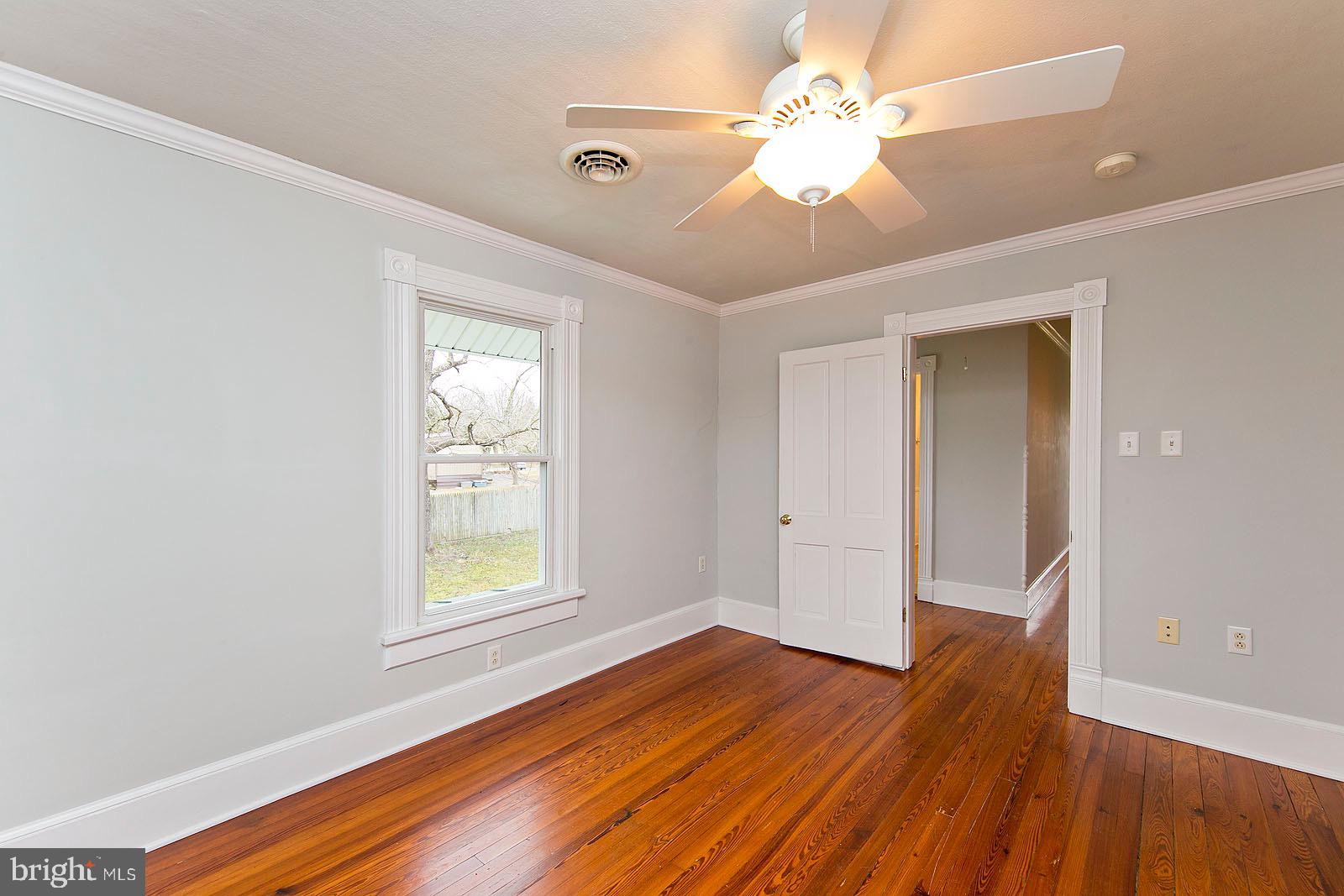 713 Rileyville Road Rileyville, VA 22650 - Photo 38 of 54 a view of an empty room with wooden floor and a window