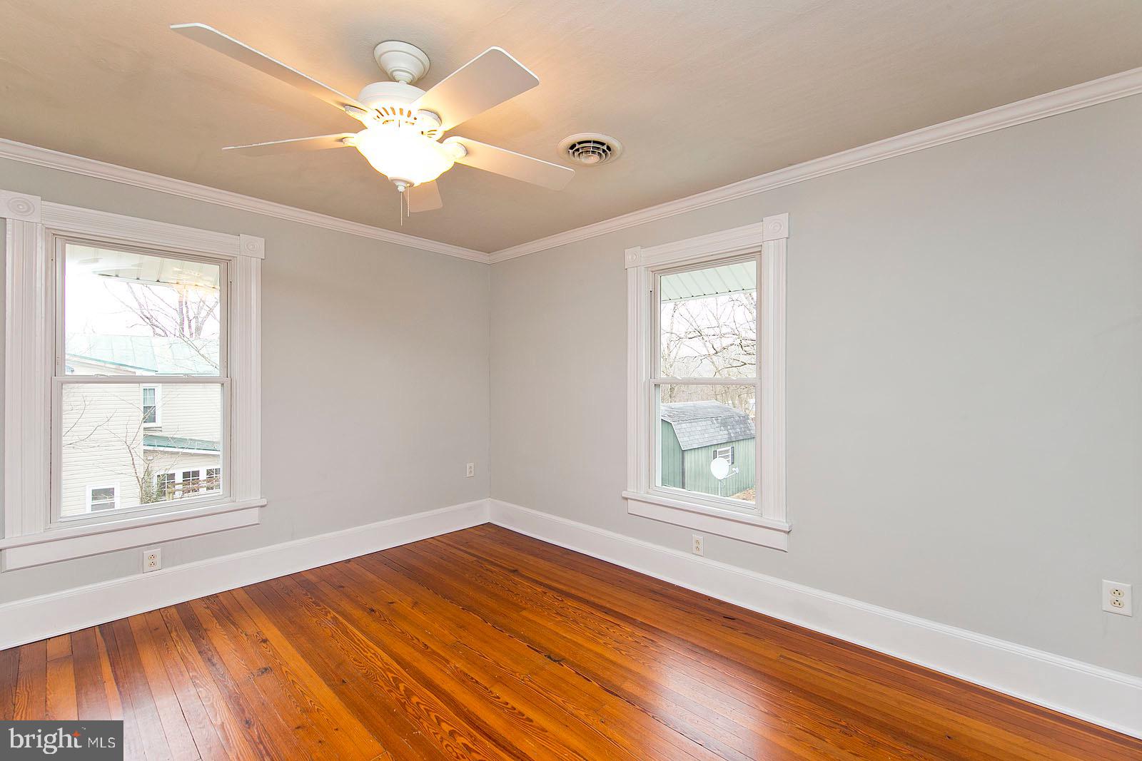 713 Rileyville Road Rileyville, VA 22650 - Photo 39 of 54 a view of an empty room with wooden floor and a window