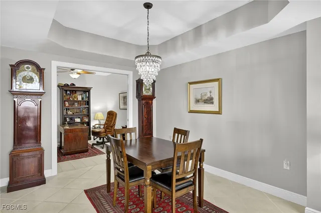 a view of a dining room with furniture a chandelier and wooden floor