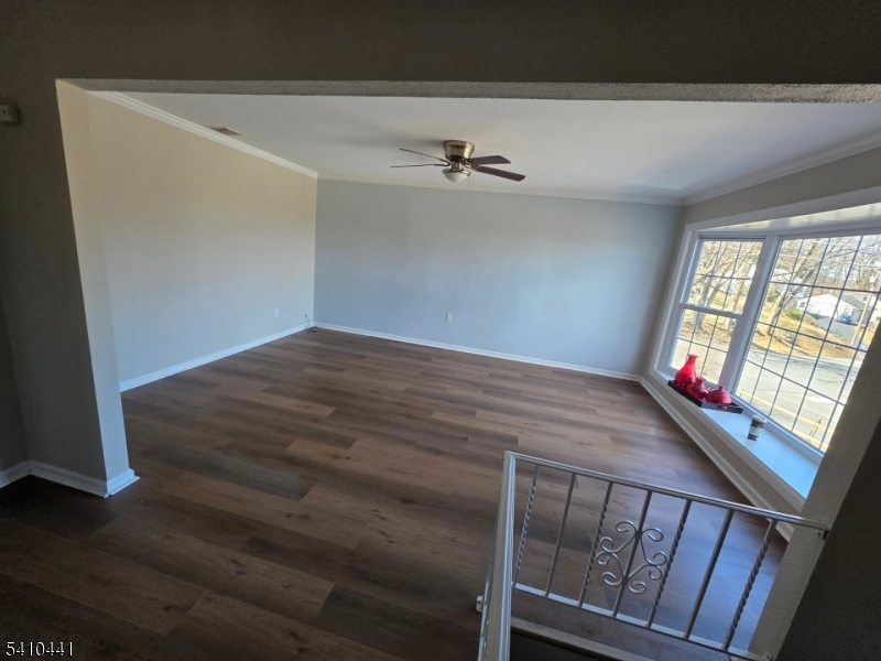 14 Oliver Road Landing, NJ 07850 - Photo 2 of 17 a view of empty room with wooden floor and fan
