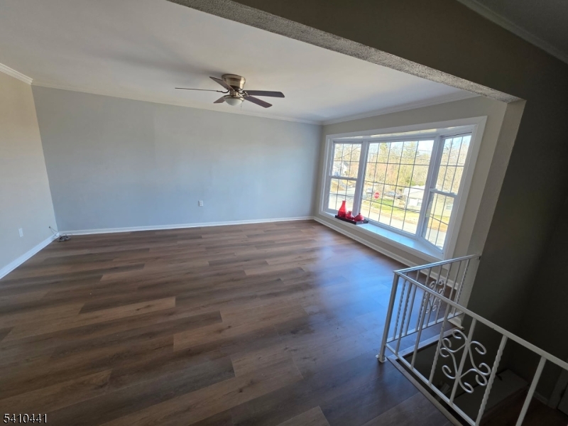 14 Oliver Road Landing, NJ 07850 - Photo 4 of 17 an empty room with wooden floor fan and windows
