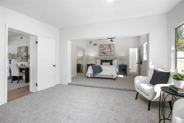 a bedroom with furniture and a lamp