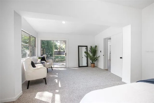 a living room with furniture and large windows