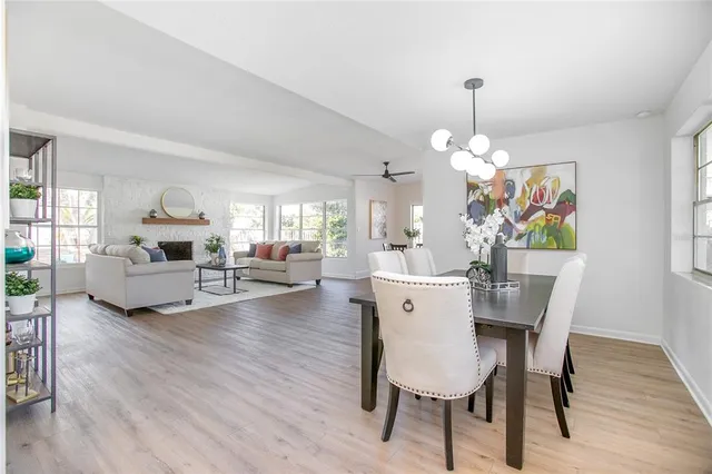 a view of a dining room with furniture wooden floor and chandelier