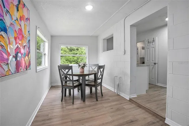 a view of a dining room with furniture window and wooden floor