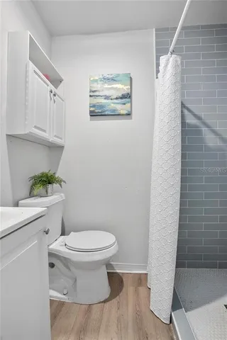 a bathroom with a toilet and a shower