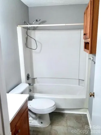 a bathroom with a toilet and a bathtub