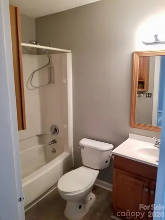 a white toilet sitting next to a bathtub