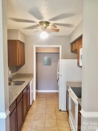 a kitchen with a sink and a stove top oven