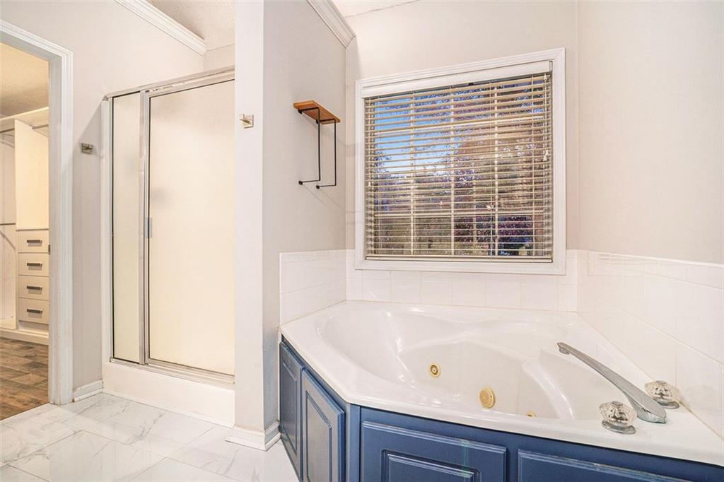 3205 Haleys Way Southeast Conyers, GA 30013 - Photo 12 of 25 a bathroom with a bathtub and a shower
