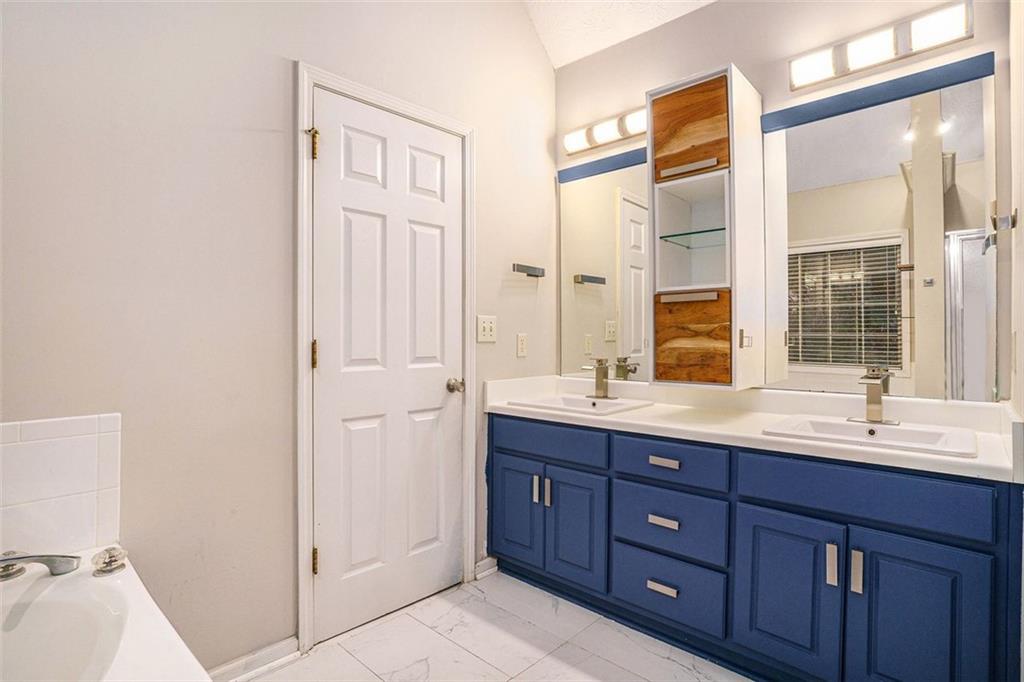 3205 Haleys Way Southeast Conyers, GA 30013 - Photo 13 of 25 a bathroom with a double vanity sink and a mirror