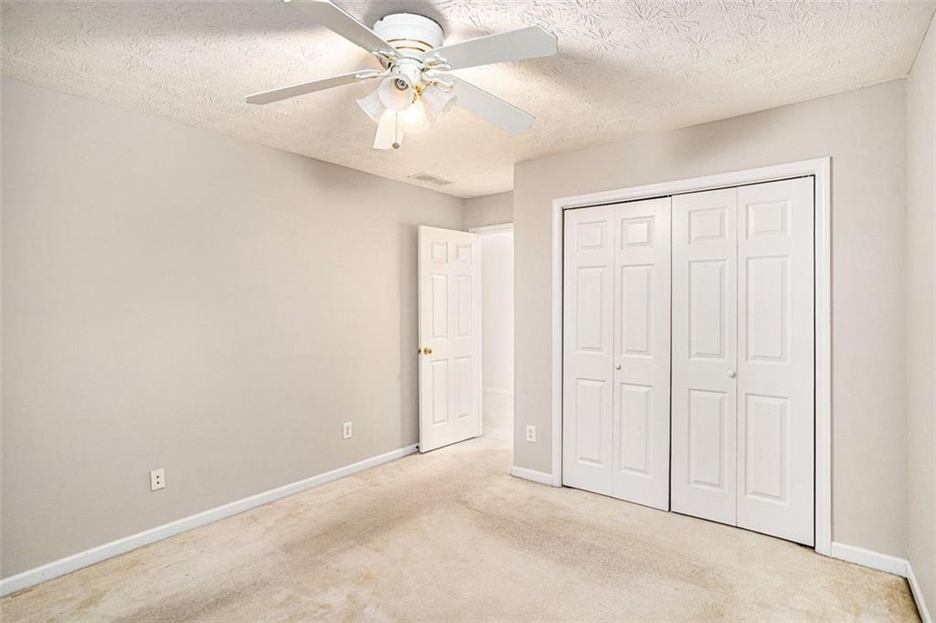 3205 Haleys Way Southeast Conyers, GA 30013 - Photo 15 of 25 an empty room with a ceiling fan and a window