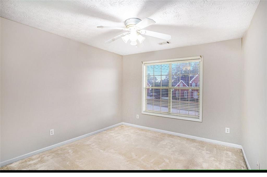 3205 Haleys Way Southeast Conyers, GA 30013 - Photo 16 of 25 an empty room with windows and fan
