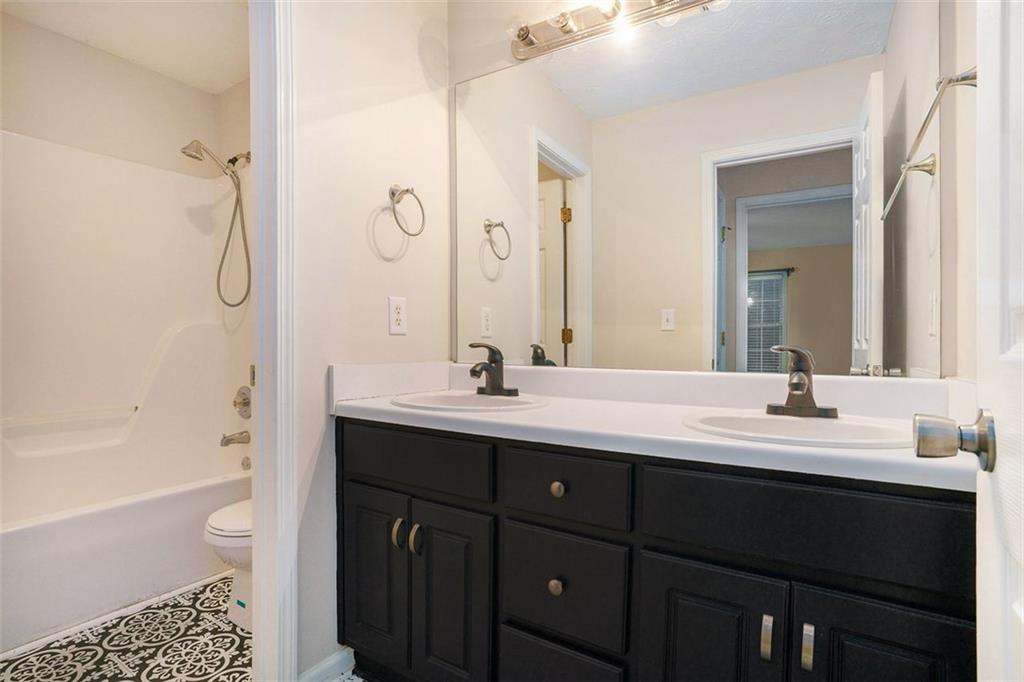 3205 Haleys Way Southeast Conyers, GA 30013 - Photo 20 of 25 a bathroom with a double vanity sink toilet mirror and bathtub