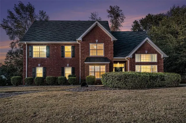 a front view of a house with a yard