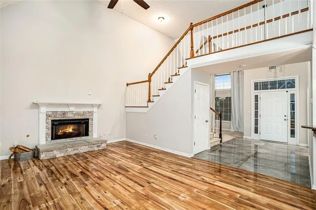 a view of a livingroom with wooden floor and a fireplace