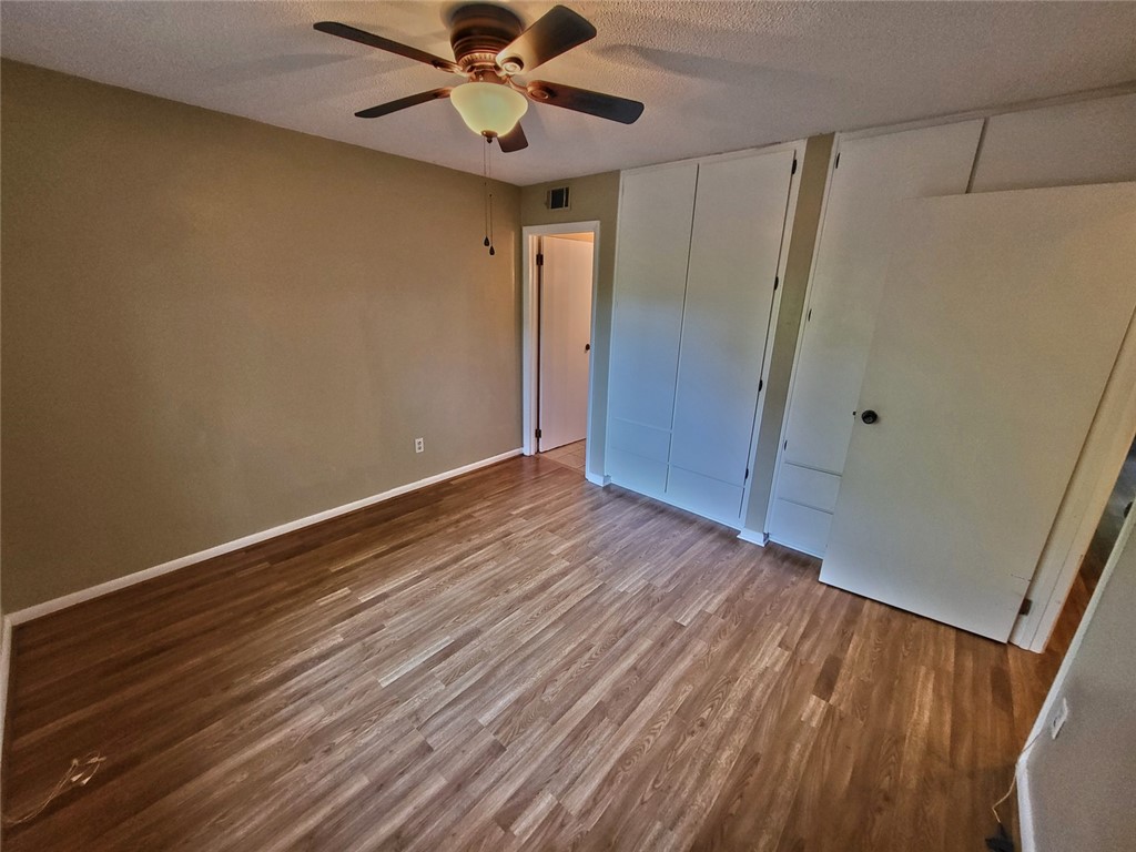 150 Ligon Street, Unit 1001 Clemson, SC 29631 - Photo 14 of 29 Natural wood flooring complements built-in storage in this accommodating bedroom.
