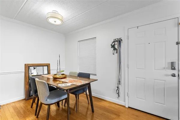 a view of a dining room with furniture and wooden floor