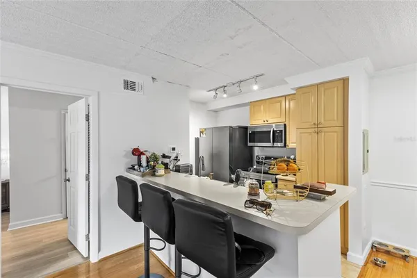 a kitchen with stainless steel appliances a sink stove and refrigerator