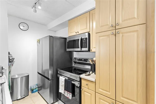 a kitchen with stainless steel appliances a refrigerator stove and microwave