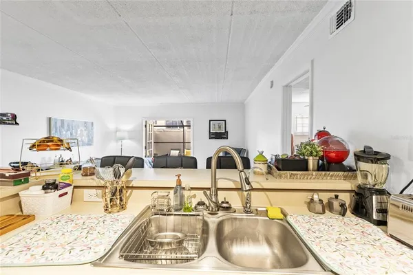 a kitchen with a sink and a white stove next to a window