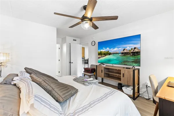 a bedroom with a bed and a flat screen tv
