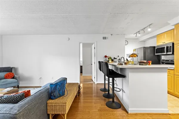 a kitchen with stainless steel appliances kitchen island granite countertop a refrigerator and microwave