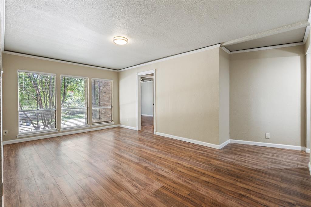 5634 Boca Raton Boulevard, Unit 209 Fort Worth, TX 76112 - Photo 7 of 24 a view of an empty room with wooden floor and a window