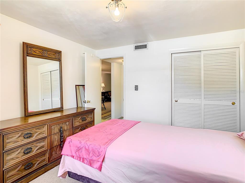 4230 Redcliff Place, Unit 4230 New Port Richey, FL 34652 - Photo 23 of 42 a bedroom with a bed and a dresser