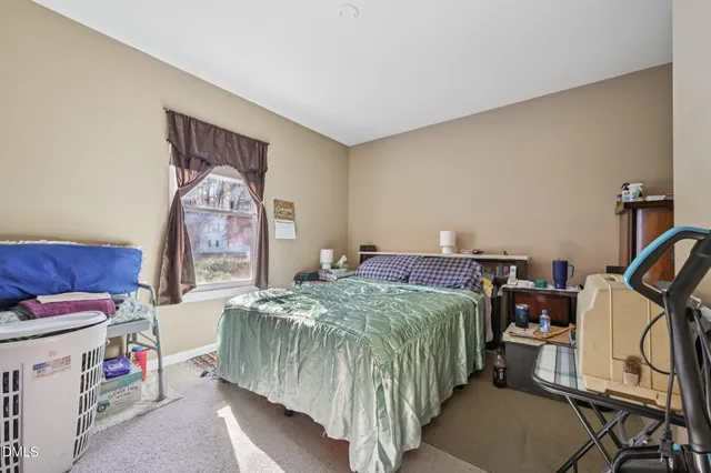 a bedroom with a bed and a dresser