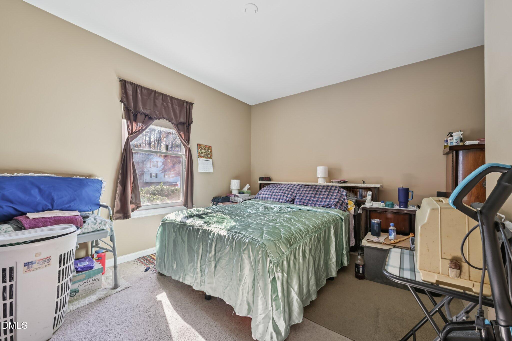 2706 Ramblegate Lane Durham, NC 27705 - Photo 10 of 28 a bedroom with a bed and a dresser