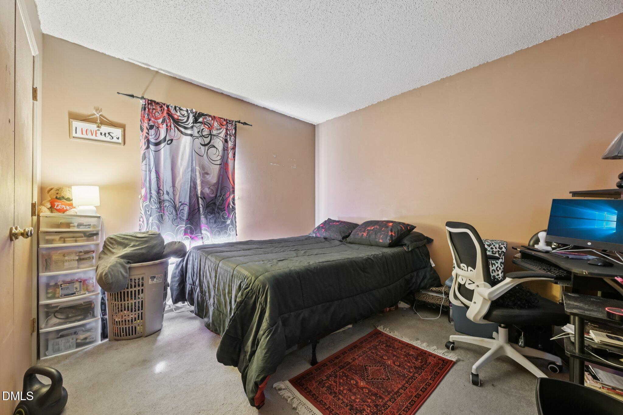 2706 Ramblegate Lane Durham, NC 27705 - Photo 14 of 28 a bedroom with a bed and a desk