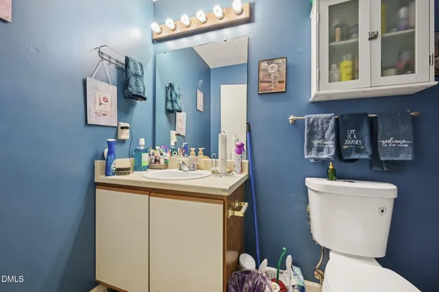 a bathroom with a toilet sink and mirror