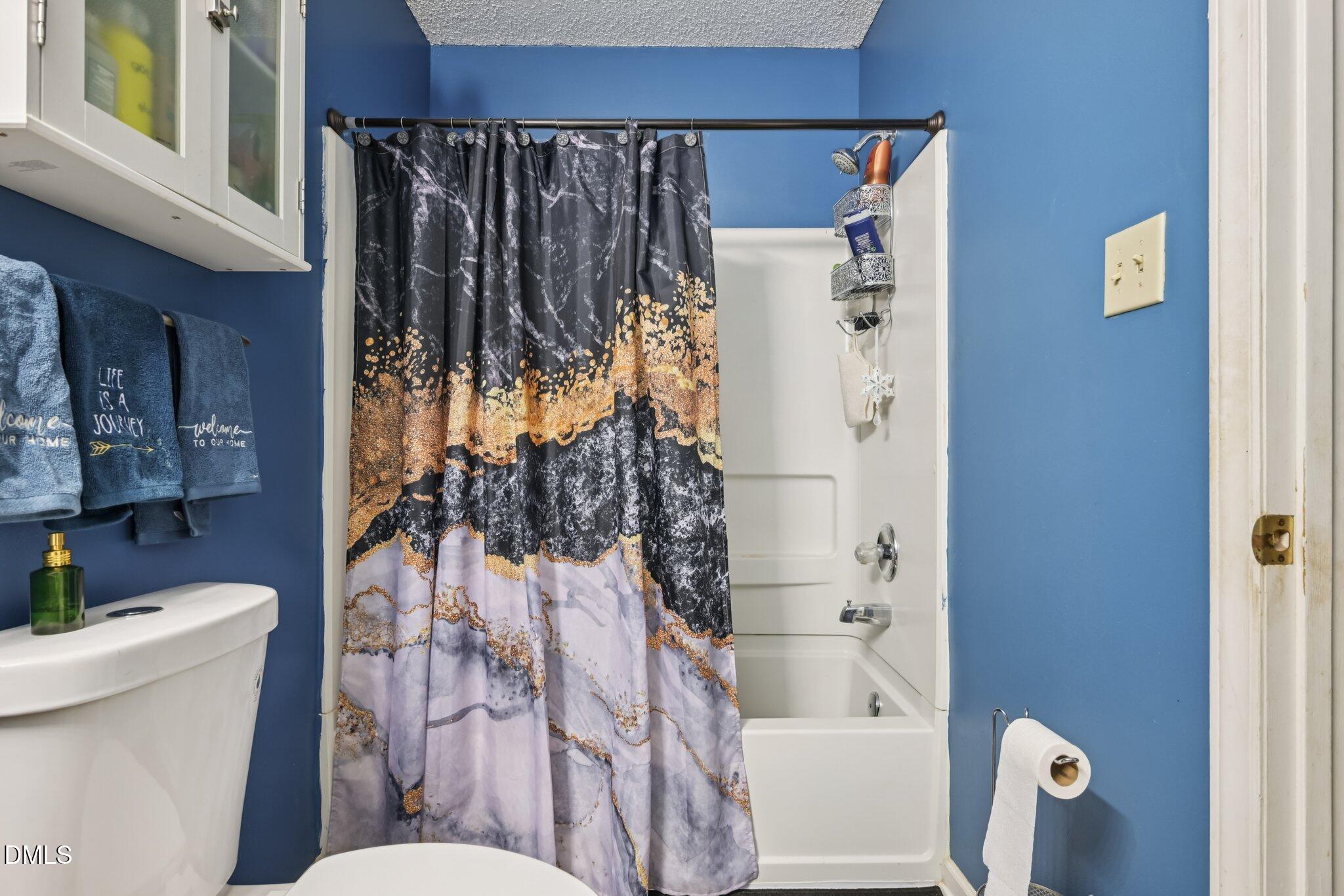 2706 Ramblegate Lane Durham, NC 27705 - Photo 18 of 28 a bathroom with a bathtub and shower
