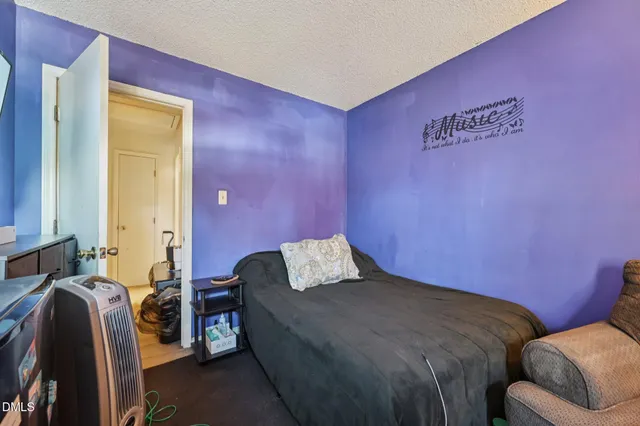 a bedroom with a bed and chair