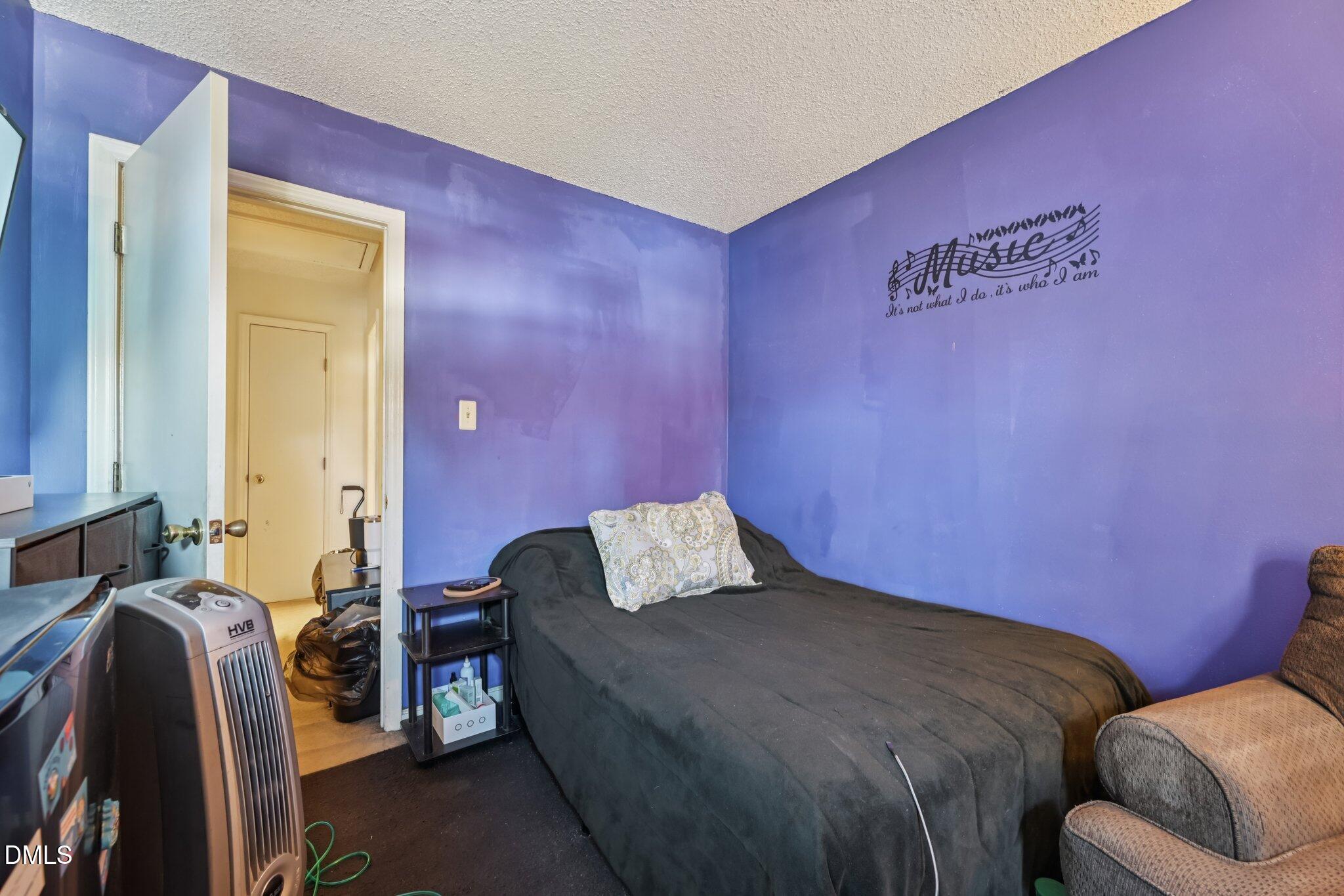 2706 Ramblegate Lane Durham, NC 27705 - Photo 20 of 28 a bedroom with a bed and chair