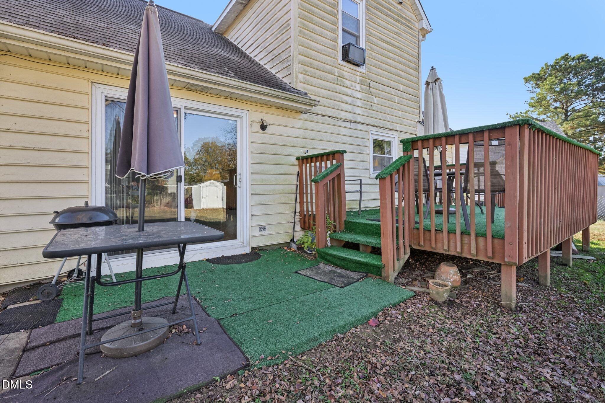 2706 Ramblegate Lane Durham, NC 27705 - Photo 21 of 28 a backyard of a house with barbeque oven table and chairs