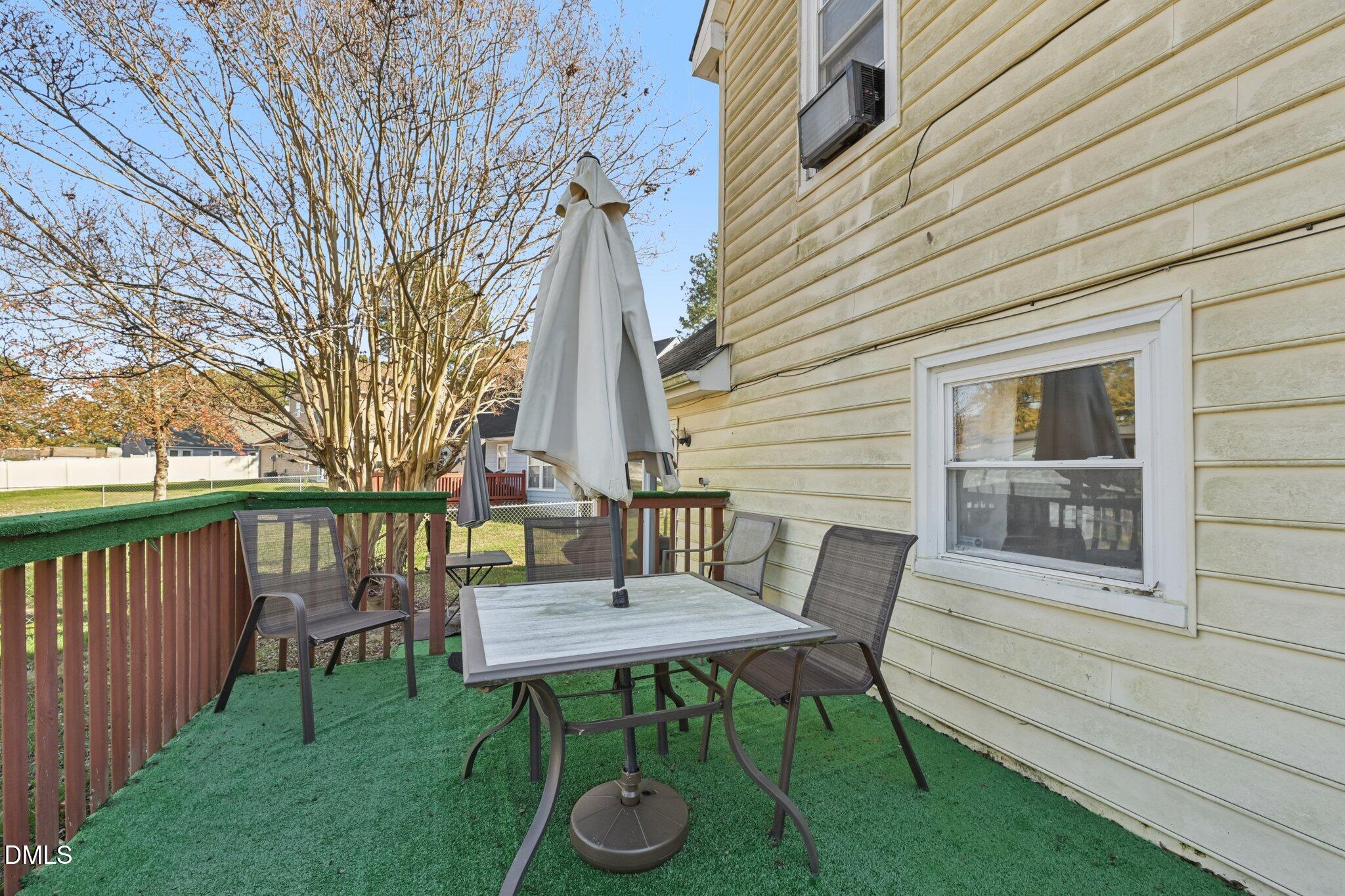 2706 Ramblegate Lane Durham, NC 27705 - Photo 24 of 28 a view of a deck with table and chairs and wooden fence