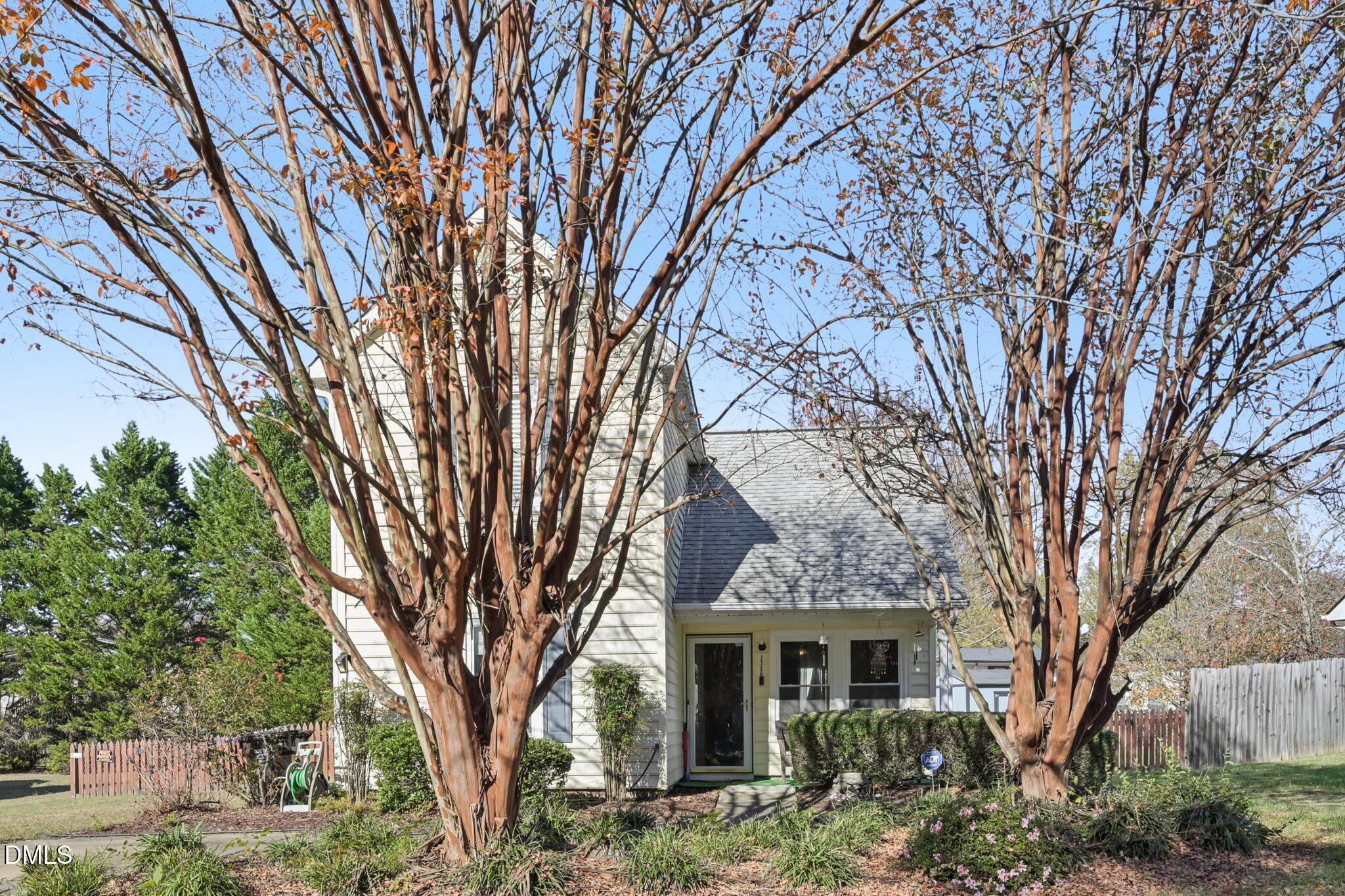 2706 Ramblegate Lane Durham, NC 27705 - Photo 27 of 28 a front view of a house with a garden