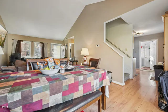 a bedroom with a bed a mirror and lamp on table