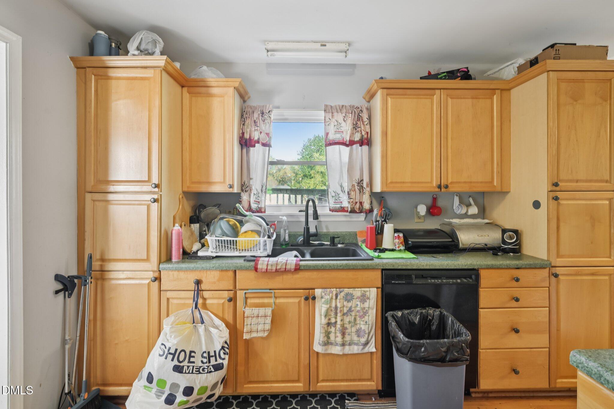 2706 Ramblegate Lane Durham, NC 27705 - Photo 8 of 28 a kitchen with stainless steel appliances a refrigerator sink and cabinets