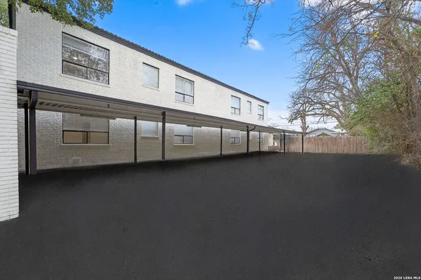 a view of a hallway with wooden floor and entryway