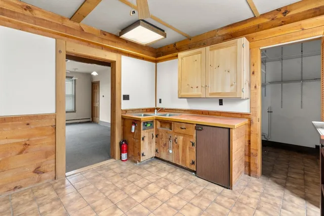 a view of a kitchen with stainless steel appliances granite countertop a stove a sink and a refrigerator