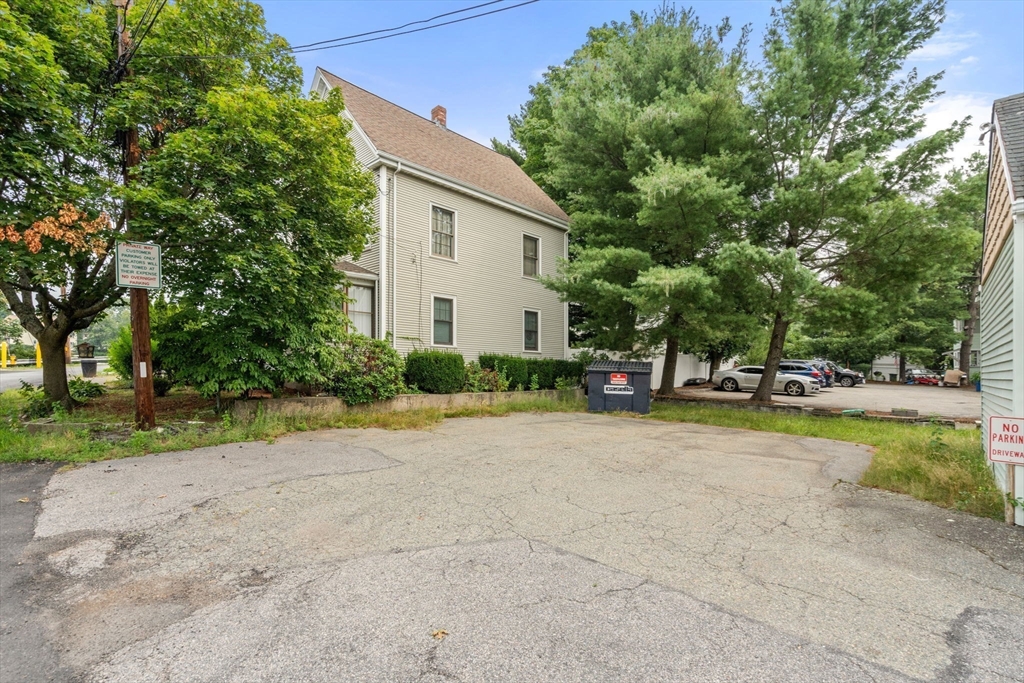 301 River Street Waltham, MA 02453 - Photo 16 of 20 a view of a tree in front of a house