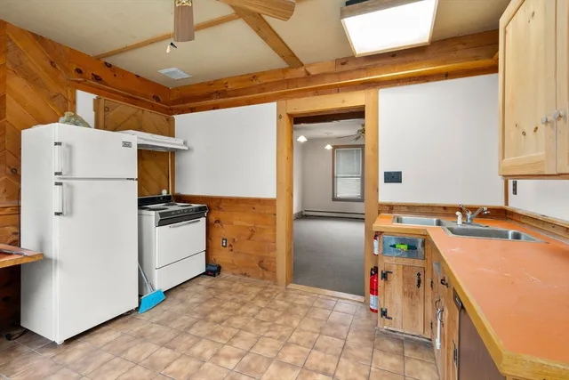 a kitchen with refrigerator and white cabinets