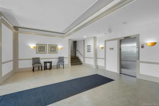 a living room with furniture and a dining table
