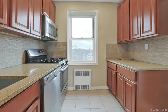 a kitchen with stainless steel appliances granite countertop a sink and a stove