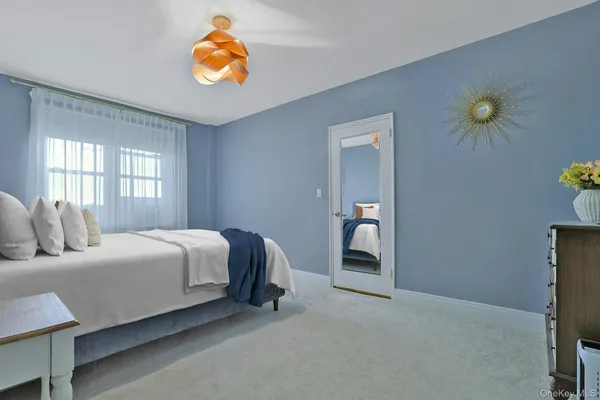 a bedroom with a bed and window