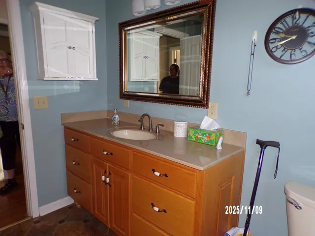 a bathroom with a toilet a sink and a mirror