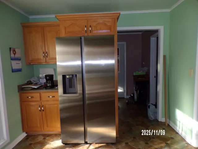 a kitchen with stainless steel appliances granite countertop a refrigerator and a stove